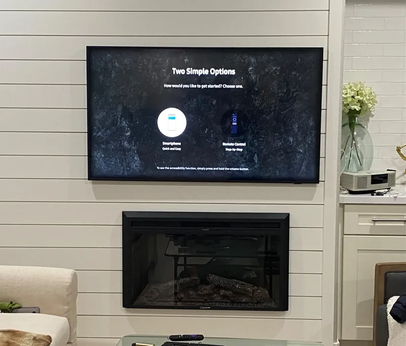 65-inch Samsung Frame TV above shiplap fireplace with concealed wiring in Cupertino