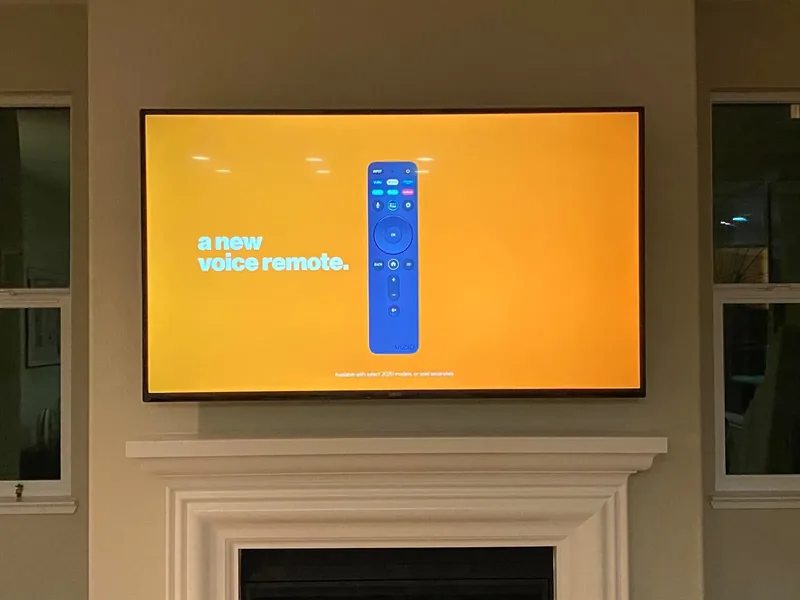 75-inch Vizio TV mounted over a fireplace in Pacific Grove