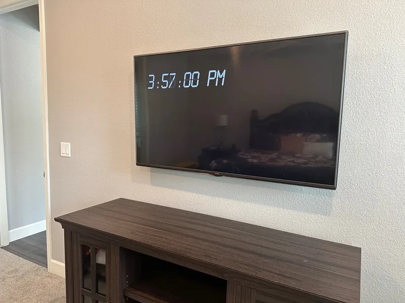 65-inch LG TV wall-mounted with cables concealed inside the wall in Salinas