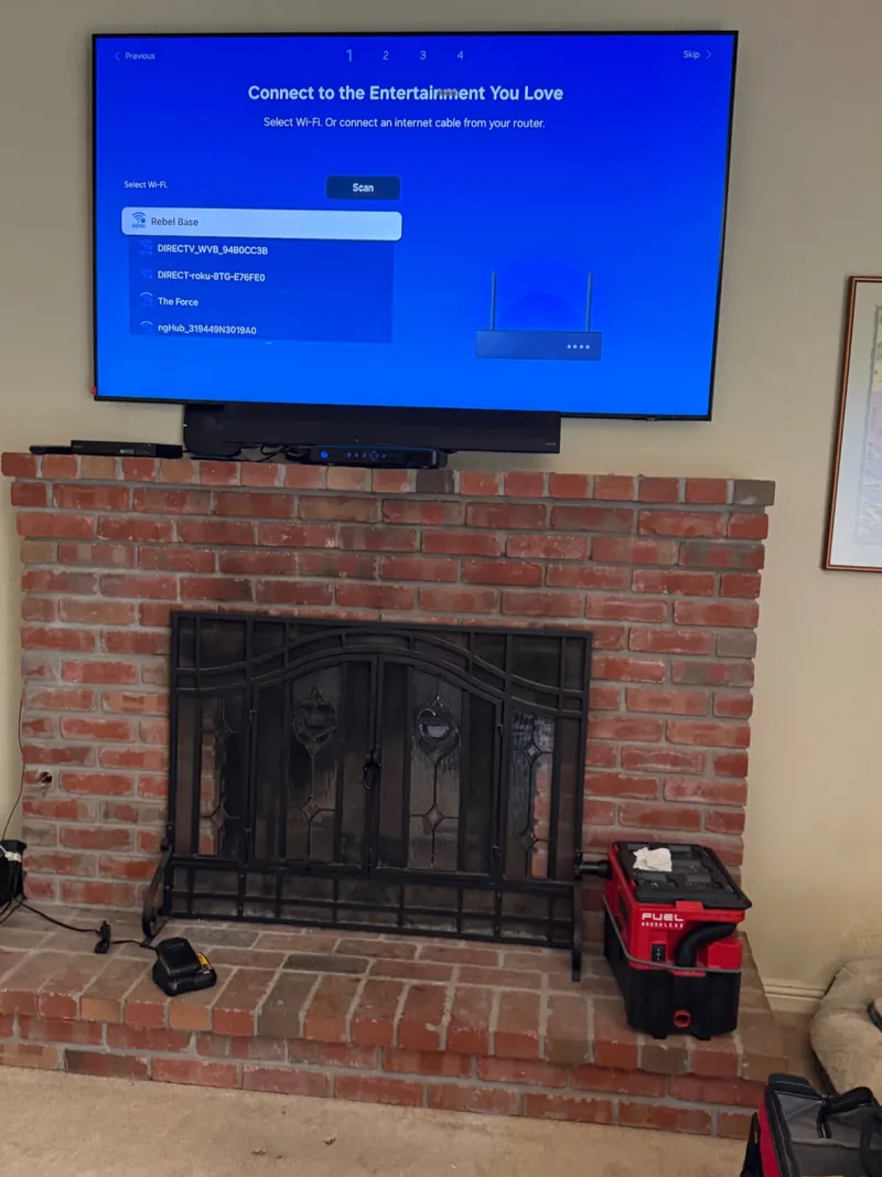 TV and soundbar above a brick fireplace in San Francisco.