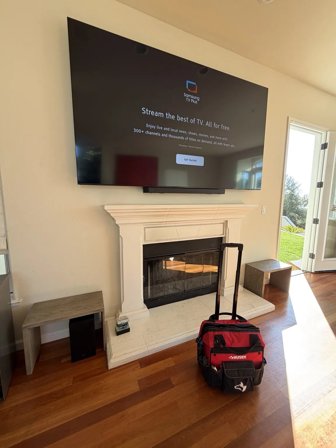 98″ Samsung TV mounted over a fireplace with a soundbar in Aptos, CA