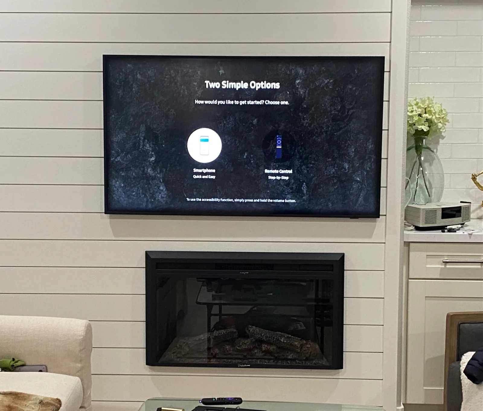 65″ Samsung Frame TV mounted over a fireplace on a shiplap wall with in-wall cable concealment in Cupertino, CA