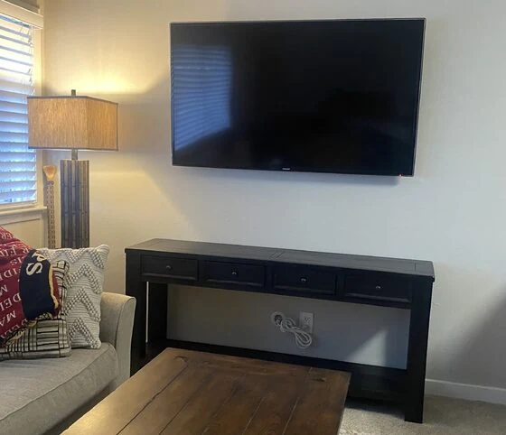 Wall-mounted TV above a console table with in-wall power concealment in Morgan Hill
