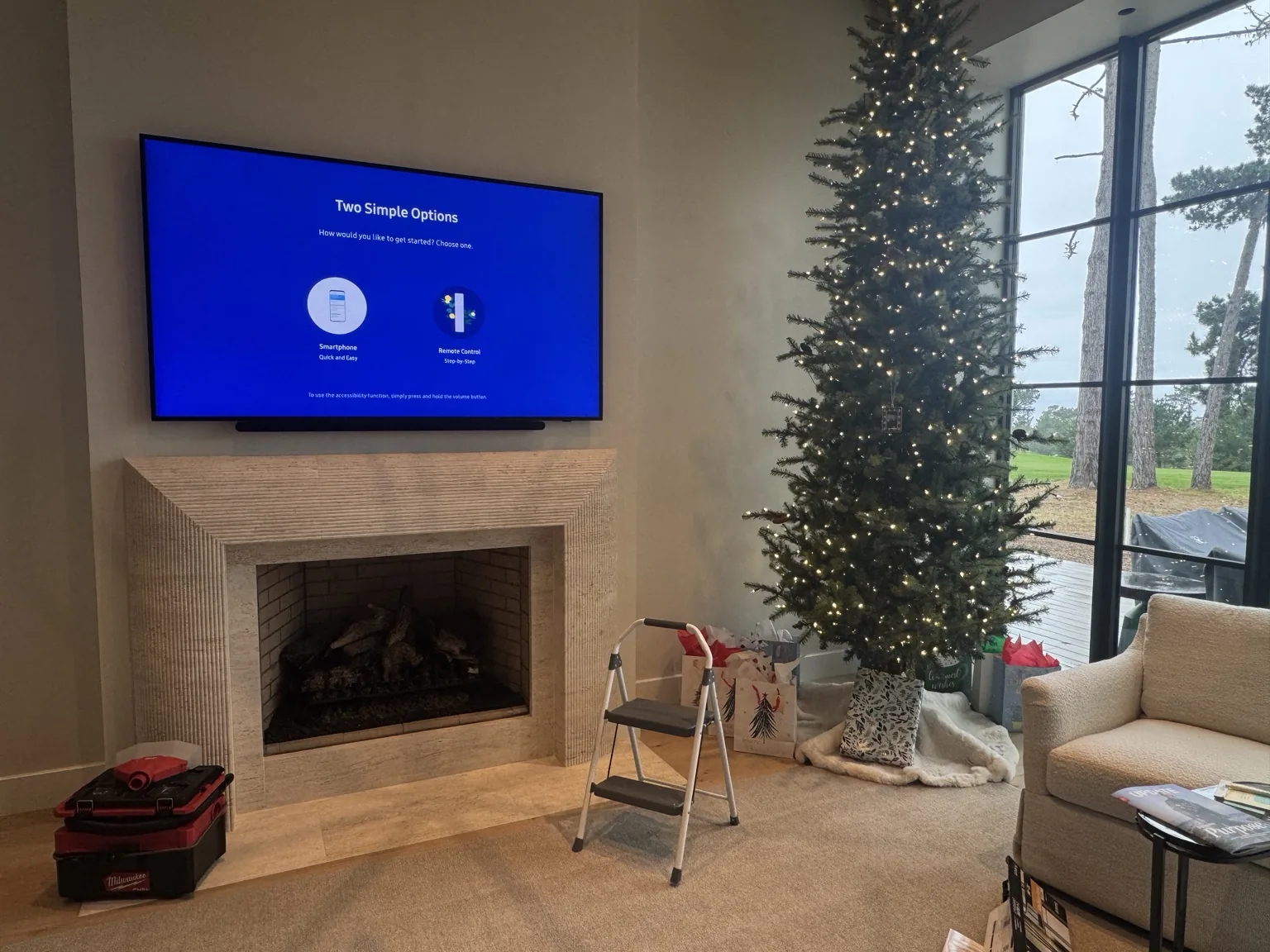 85″ Samsung TV mounted over a fireplace with a soundbar mounted directly underneath in Pebble Beach, CA