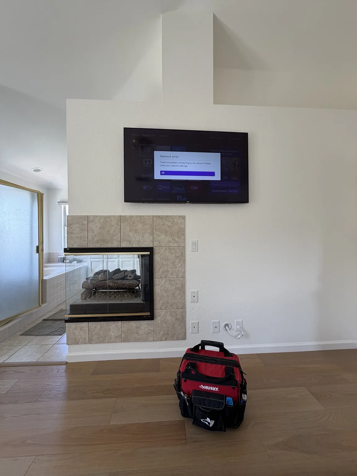 55-inch TCL TV above a fireplace with concealed in-wall wiring in Salinas