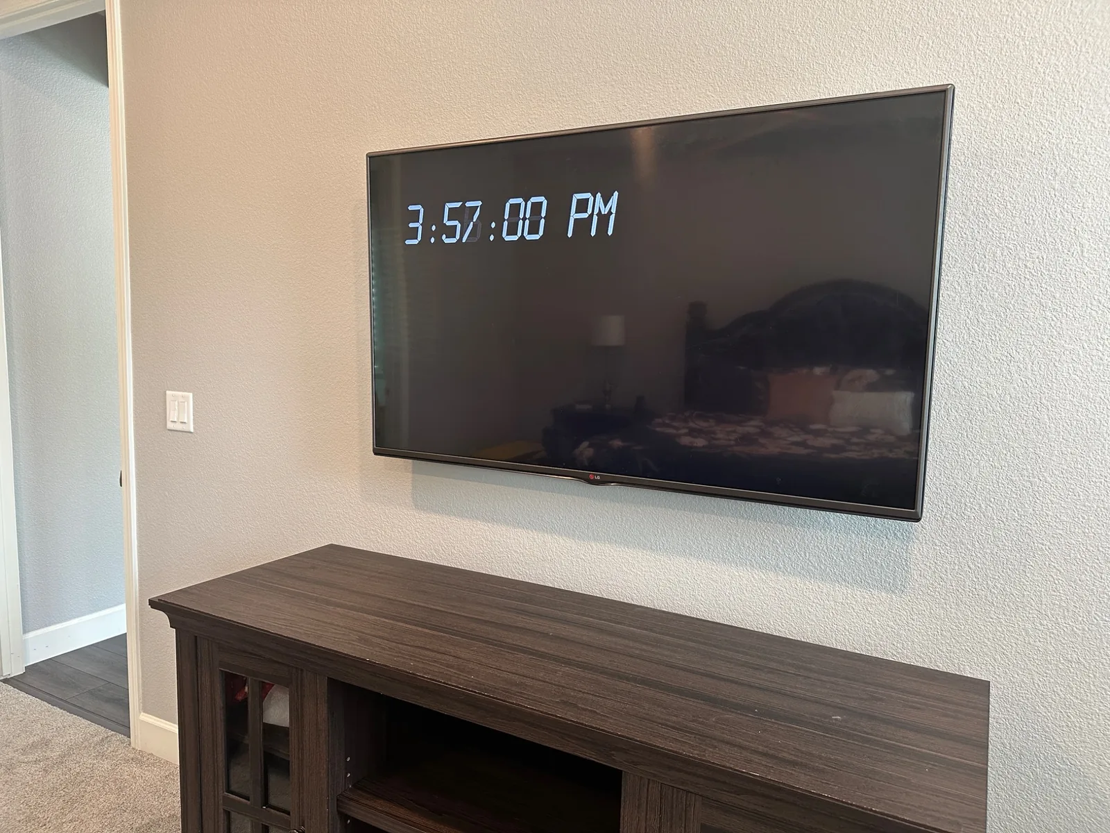 65-inch LG TV wall-mounted with cables concealed inside the wall in Salinas
