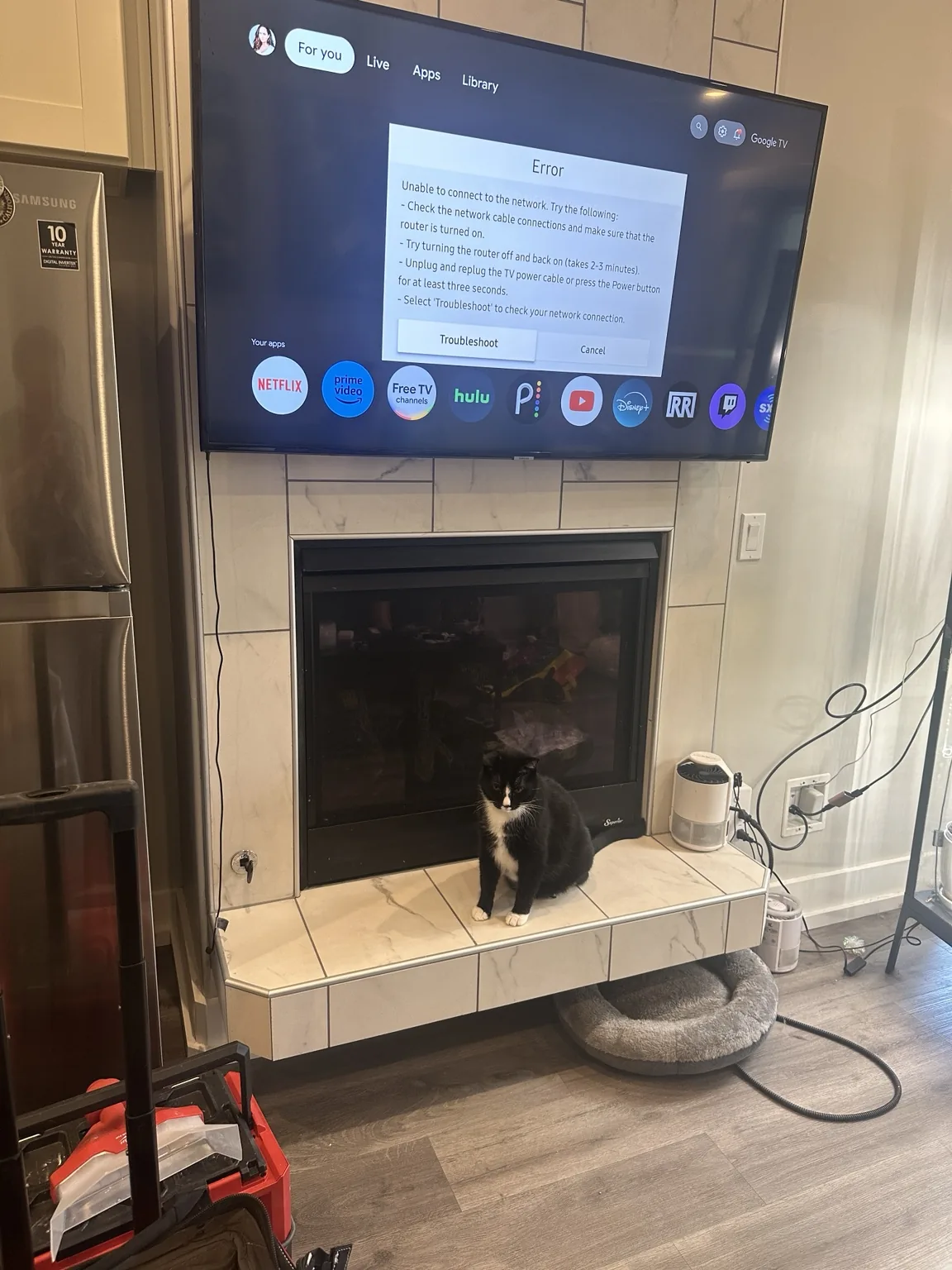 65-inch Samsung TV mounted on tile above a fireplace in Salinas