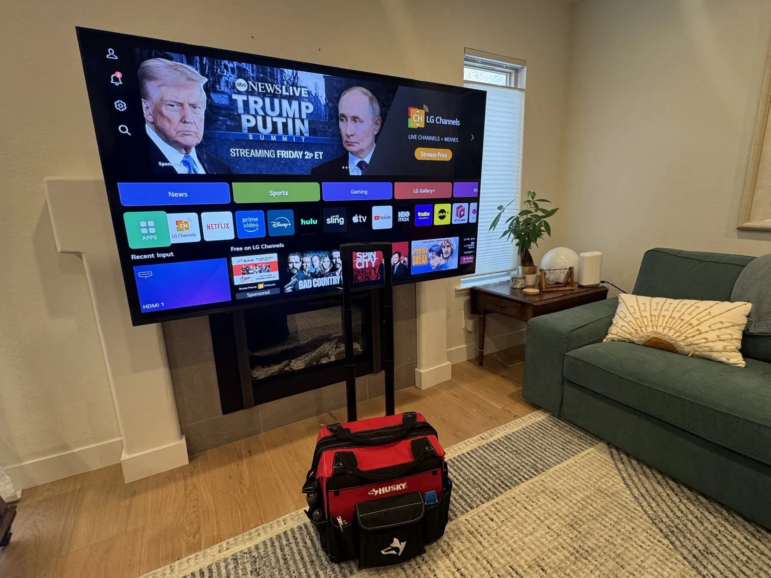 77″ LG TV on a pull-down mount over a fireplace in San Jose, CA