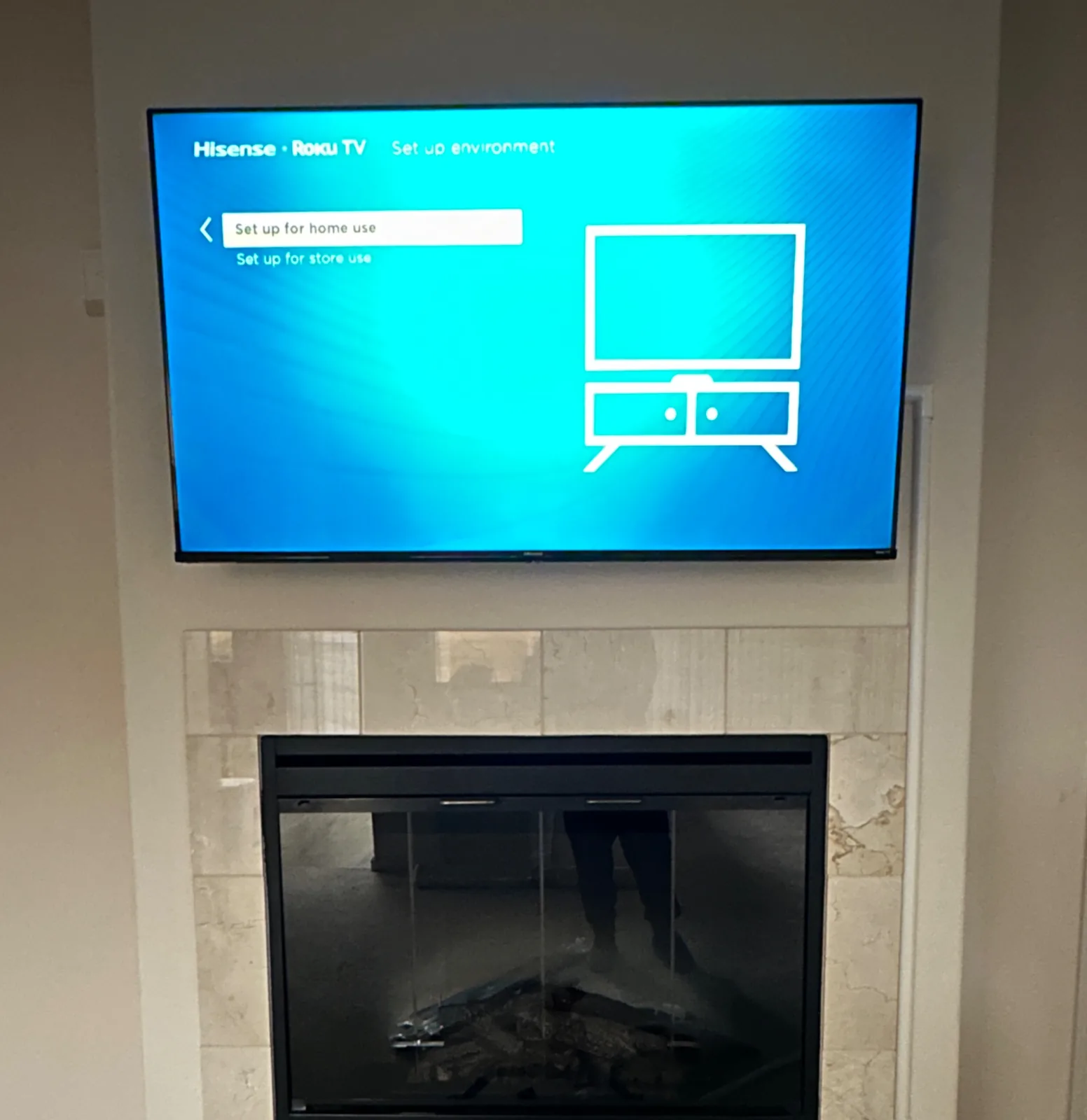 75″ Hisense TV mounted over a fireplace with external cable concealment in Seaside, CA