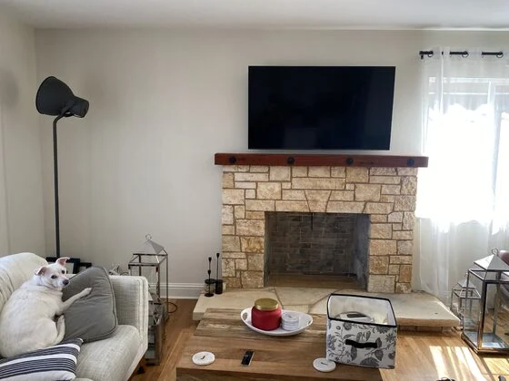 Flat-screen TV mounted above a stone fireplace in Seaside
